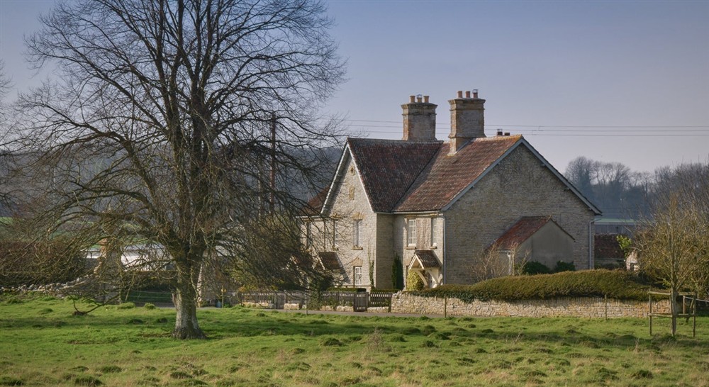 The exterior of 3 Lytes Cottage, with the Lytes Carey Manor parkland in front, Somerset at 3 Lytes Cottage in Somerton, Somerset