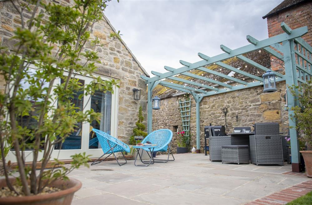 Patio area with seating for six guests to enjoy alfresco dining at 3 Mill Cottages, Yorkshire at 3 Mill Cottages, Richmond