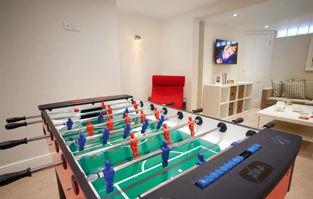 Lower Ground Floor:  A great den for younger guests, the games room has a television, football table, books and games (photo 2)