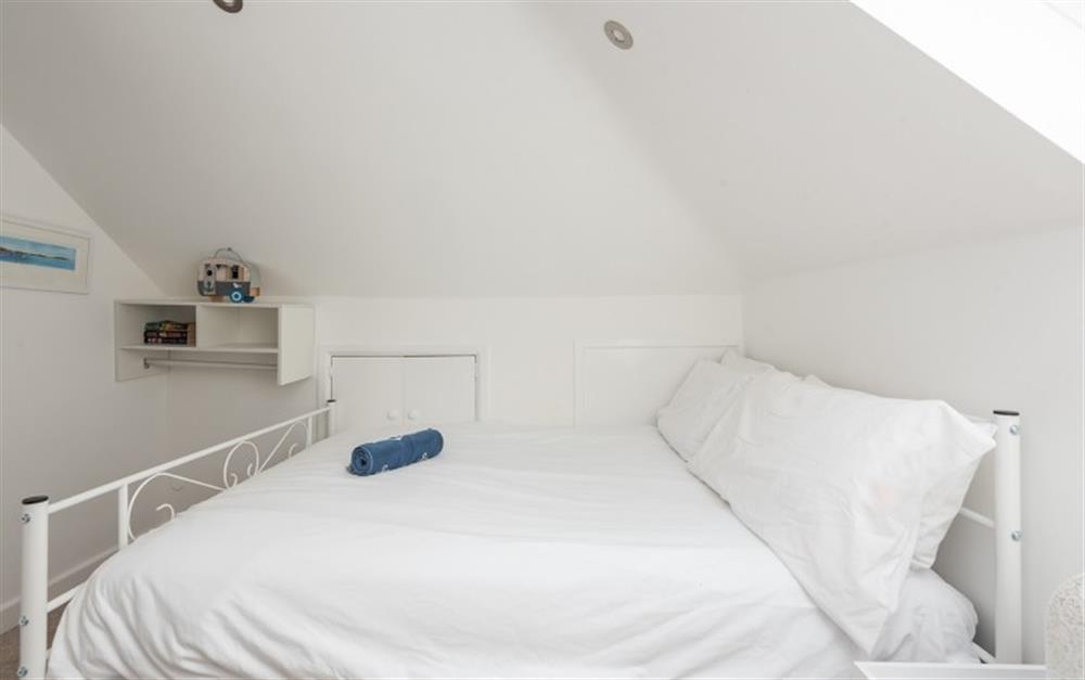 Great use has been made of the space in the second bedroom including a characterful sloped ceiling with spotlights. There is also a Velux window to the right of the photo. at 3 The Boat House in Helford Passage
