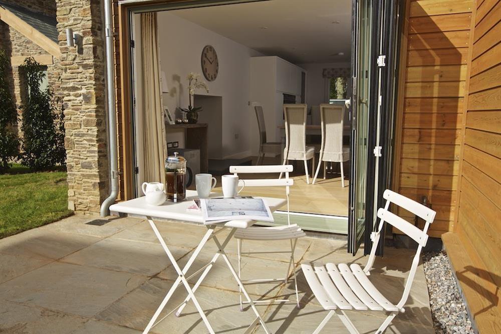 Bi-folding glass doors open to the terrace and garden at 3 The Drive in , Hillfield, Dartmouth