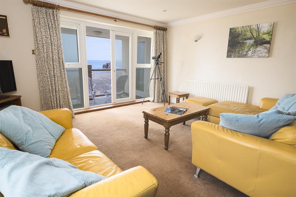 Comfortable lounge with doors to balcony at 3 Thurlestone Rock Apartments in Thurlestone, Kingsbridge