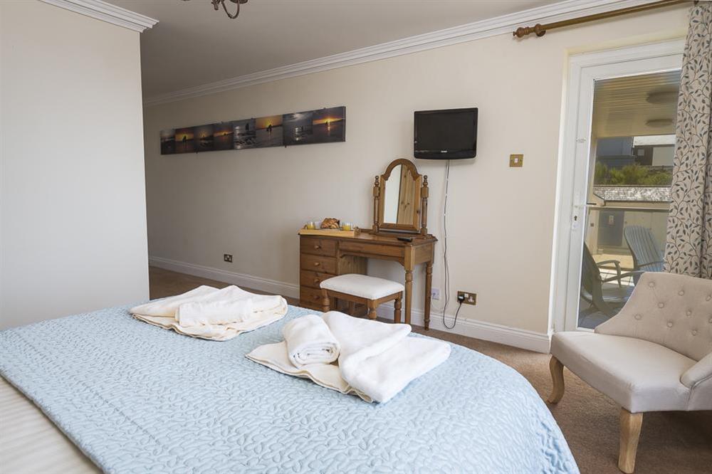 En suite master bedroom with sea views and door to balcony (photo 2) at 3 Thurlestone Rock Apartments in Thurlestone, Kingsbridge