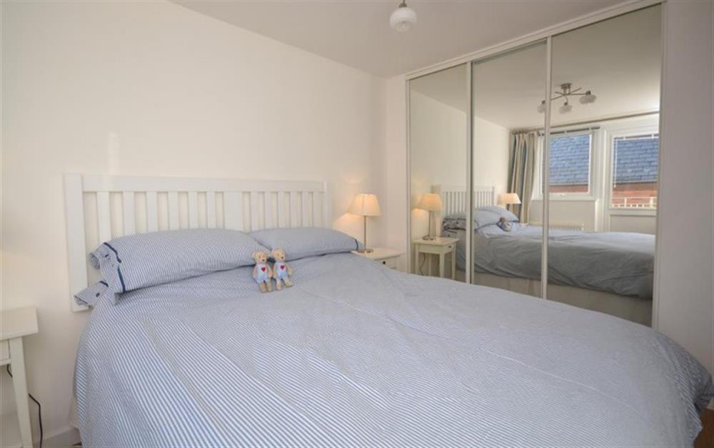 The double bedroom with king size bed and access to balcony at 3 Waters Edge in Salcombe