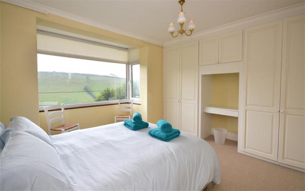 The master bedroom with lovely views to the sea and across the fields opposite. at 3 West Park Apartment in Hope Cove
