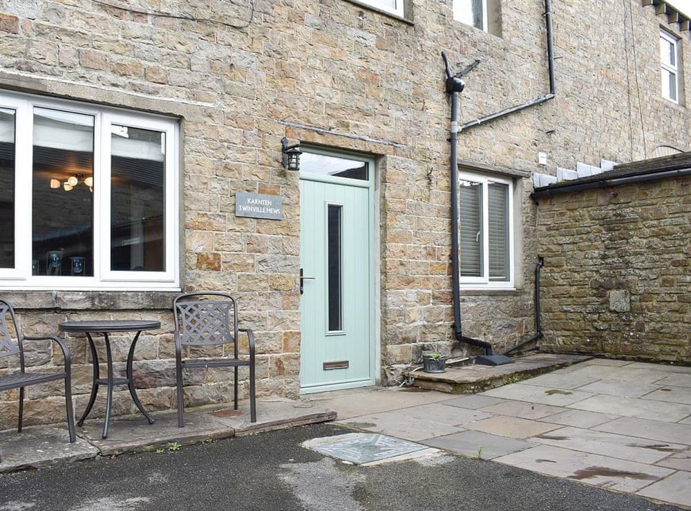 Lovely paved patio area with table and chairs at 3 Winville Mews in Askrigg, near Hawes, North Yorkshire