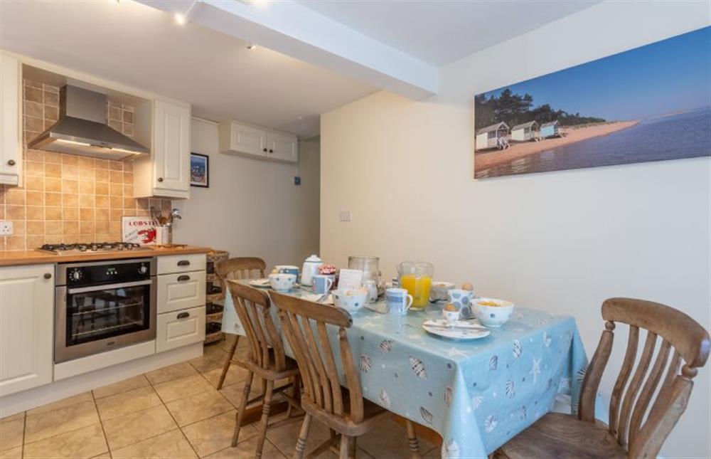 The kitchen has table with four chairs and a bench at 36 High Street, Wells-next-the-Sea
