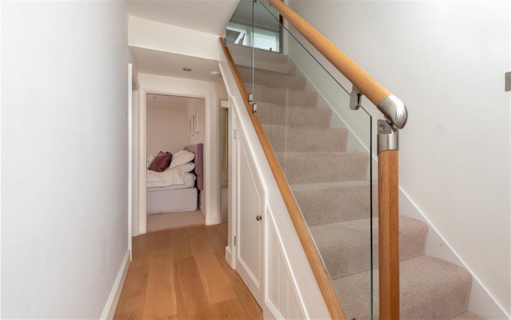 The entrance hall and stairs to the open plan living area at 3A Island Terrace in Salcombe