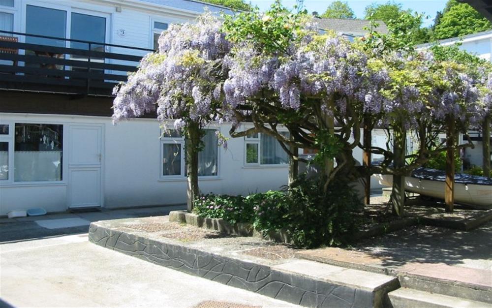 The apartment overlooks the courtyard which has a lovely wisteria growing. at 3C, The Old Sail Loft in Helford Passage