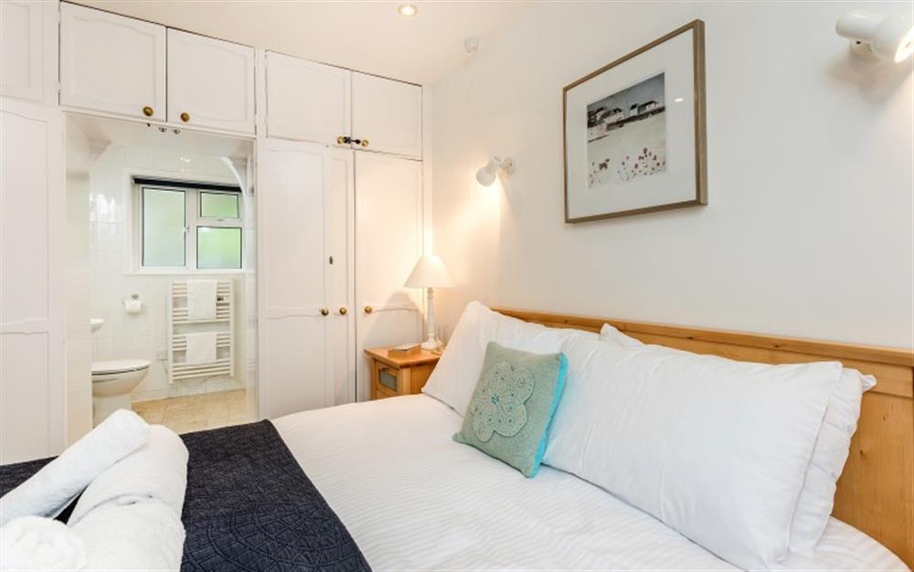 The master bedroom with the en-suite  at 3C, The Old Sail Loft in Helford Passage
