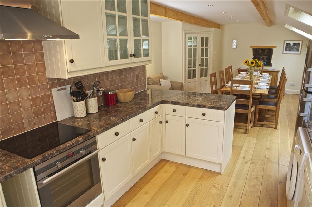 A well equipped shaker-style kitchen leading to the dining area at 4 Bolberry Court in Bolberry, Hope Cove
