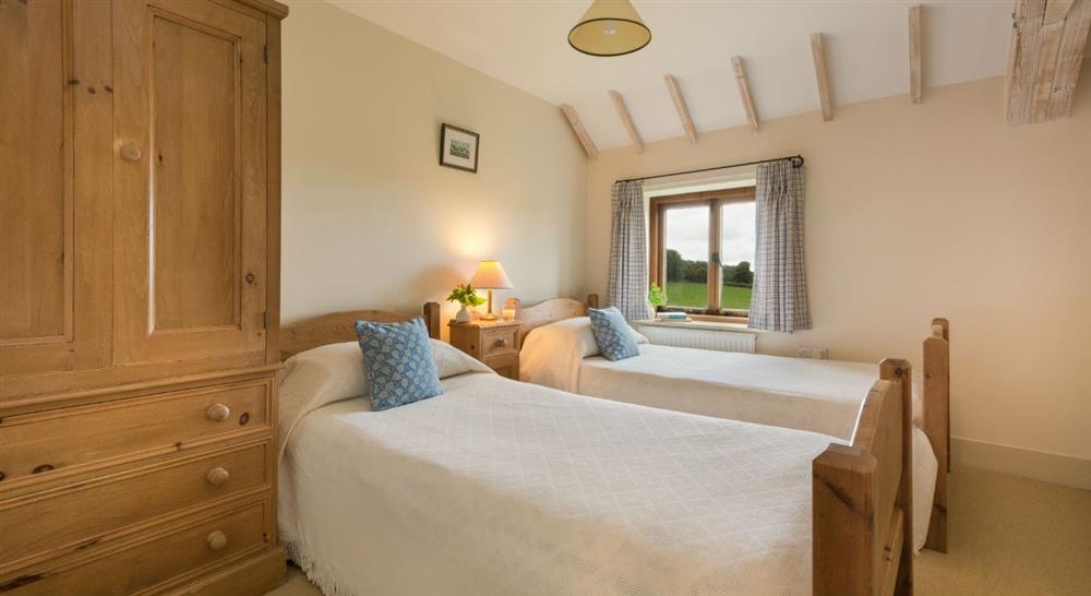 One of the bright twin bedroom at 4 Cart Lodge Barn in Upper Sheringham, Norfolk