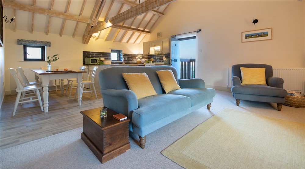 The open-plan kitchen, dining and sitting room at 4 Cart Lodge Barn in Upper Sheringham, Norfolk