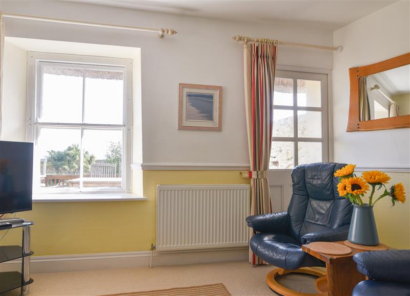 Relax in the living area (photo 2) at 4 Charmouth House, Charmouth