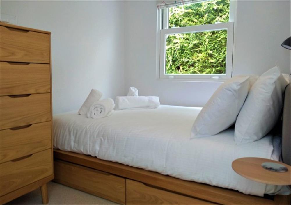 A double bed, with useful storage at 4 Coastguard Cottage in Helford Passage