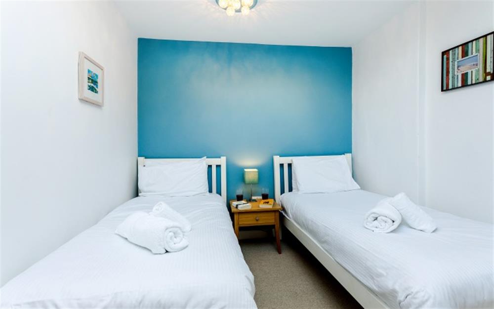 The blue feature wall of the twin bedroom is looking good against the white walls. at 4 Coastguard Cottage in Helford Passage