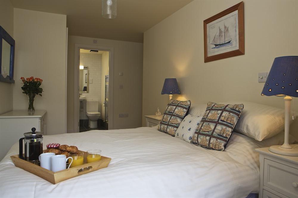 Master bedroom with double bed and en suite bathroom at 4 Combehaven in , Salcombe
