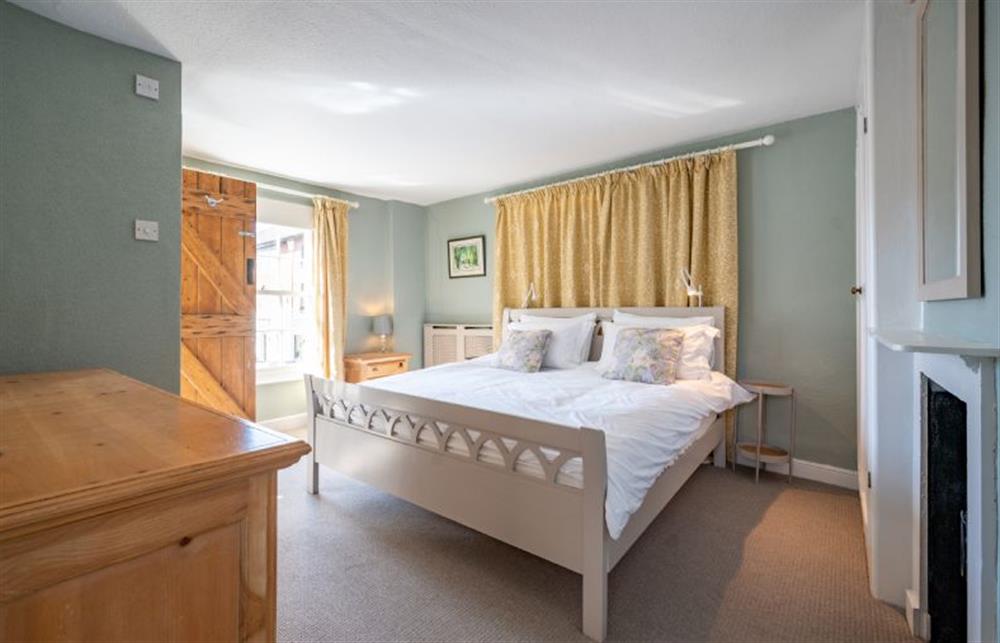 Master bedroom with a super-king size bed at 4 Cross Street, Holt