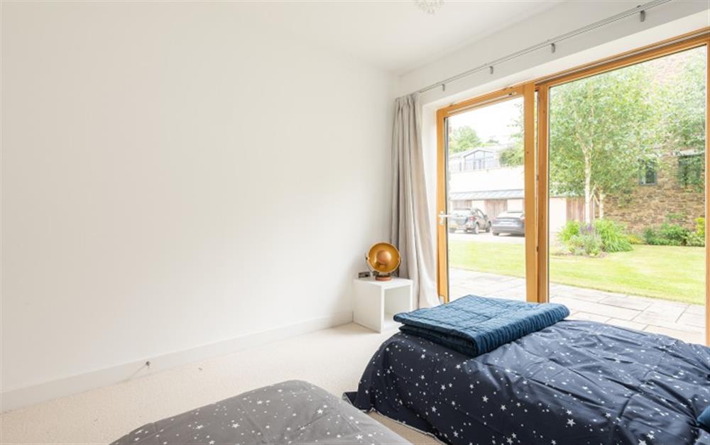 Bedroom 3 with doors to private rear patio. at 4 De Challon in East Allington