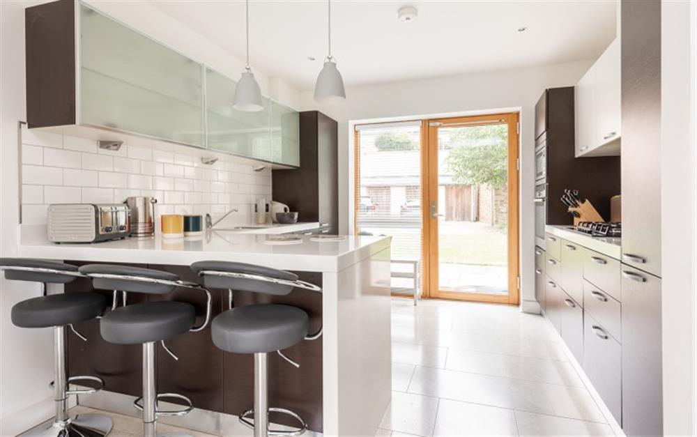 Fully integrated kitchen with breakfast bar and doors leading to private patio area. at 4 De Challon in East Allington