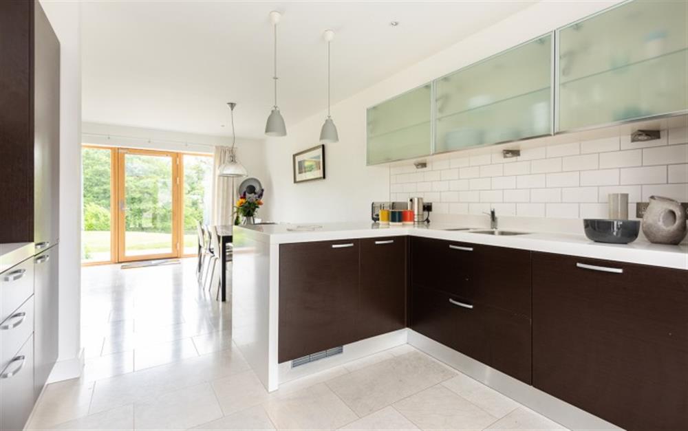 Open-plan kitchen and dining area with views to estate grounds. at 4 De Challon in East Allington