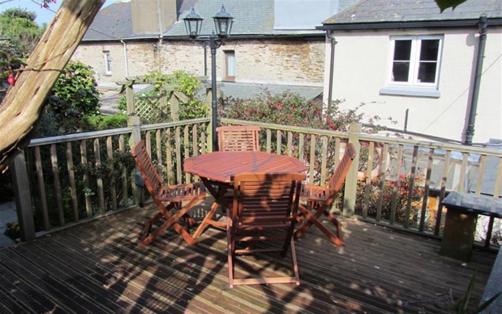 The rear decking area with garden furniture and gas barbecue at 4 Florence Cottages in Torcross