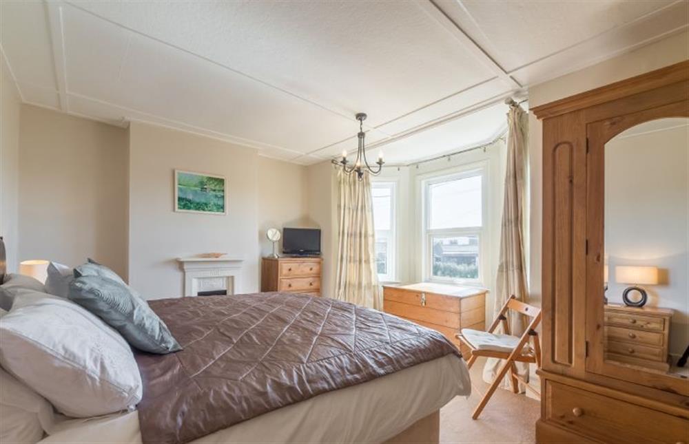 First floor: Master bedroom with bay window and marsh views at 4 Harbour View, Brancaster Staithe near Kings Lynn