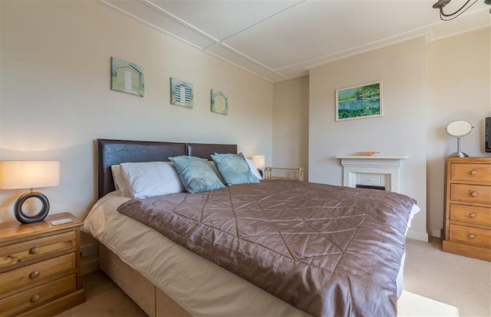 First floor: Master bedroom with King-size bed at 4 Harbour View, Brancaster Staithe near Kings Lynn