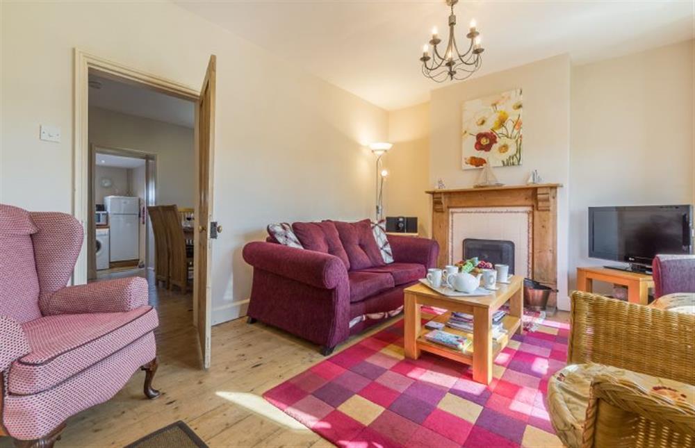 Ground floor: Sitting room with open fire at 4 Harbour View, Brancaster Staithe near Kings Lynn