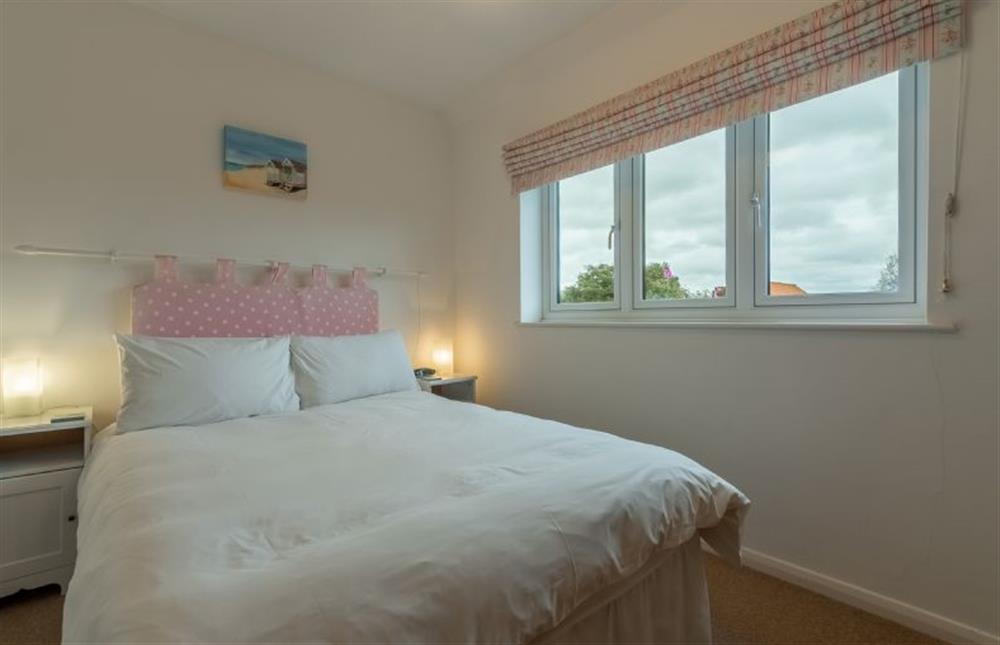 First floor: Bedroom two, double bed and garden views at 4 Langford Cottages, Ringstead near Hunstanton