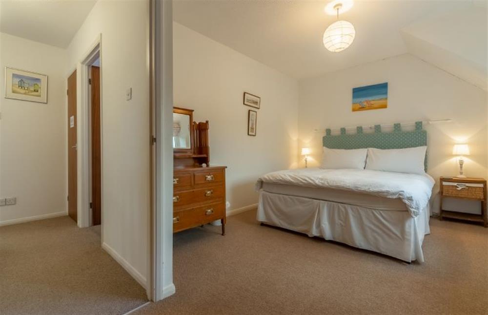 First floor: Master  bedroom with king-size bed at 4 Langford Cottages, Ringstead near Hunstanton