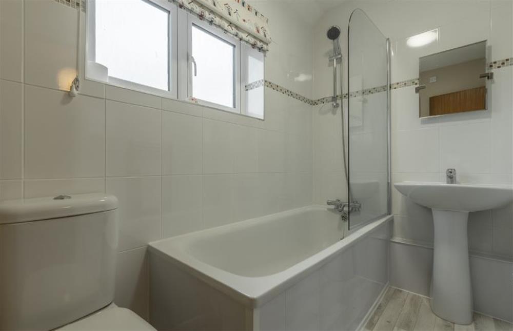 First floor: Modern family bathroom with shower over bath at 4 Langford Cottages, Ringstead near Hunstanton