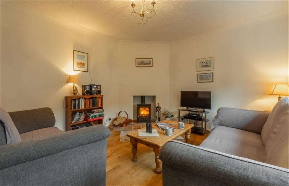 Ground floor: Sitting room has cosy wood burning stove at 4 Langford Cottages, Ringstead near Hunstanton