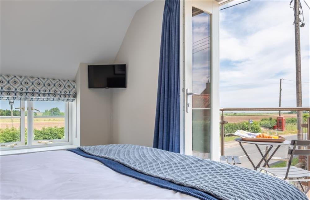 First floor: Bedroom with balcony at 4 Malthouse Cottages, Thornham near Hunstanton