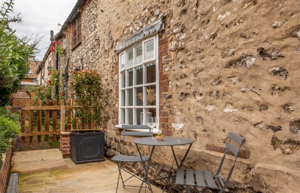 Outside: Patio area with bistro seating at 4 Malthouse Cottages, Thornham near Hunstanton