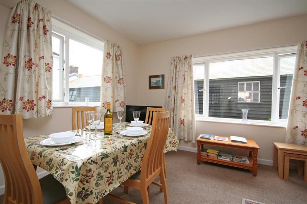 Dining table with ample space for four people at 4 Waters Edge in Thorning Street, Salcombe