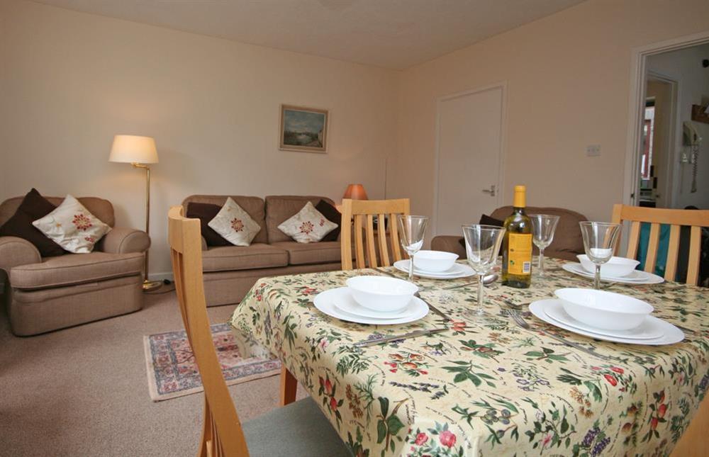 Lounge with dining table and seating for four at 4 Waters Edge in Thorning Street, Salcombe
