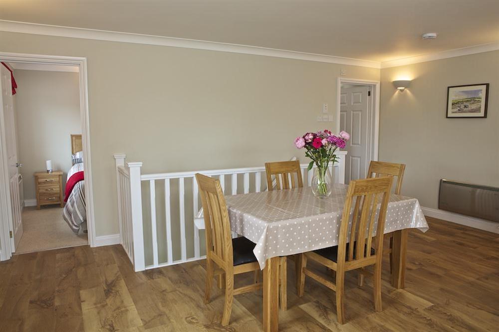 Dining area has a contemporary oak table seating four comfortably at 4 West Park Mews in Hope Cove, Kingsbridge