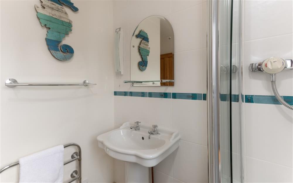 The family bathroom which is upstairs, is decorated in blues and white with a lovely seahorse featuring on the wall. at 44 Upper Stables in Maenporth