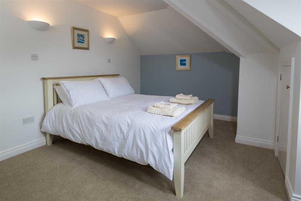 En suite master bedroom with King-size bed at 5 Chichester Court in , Hope Cove