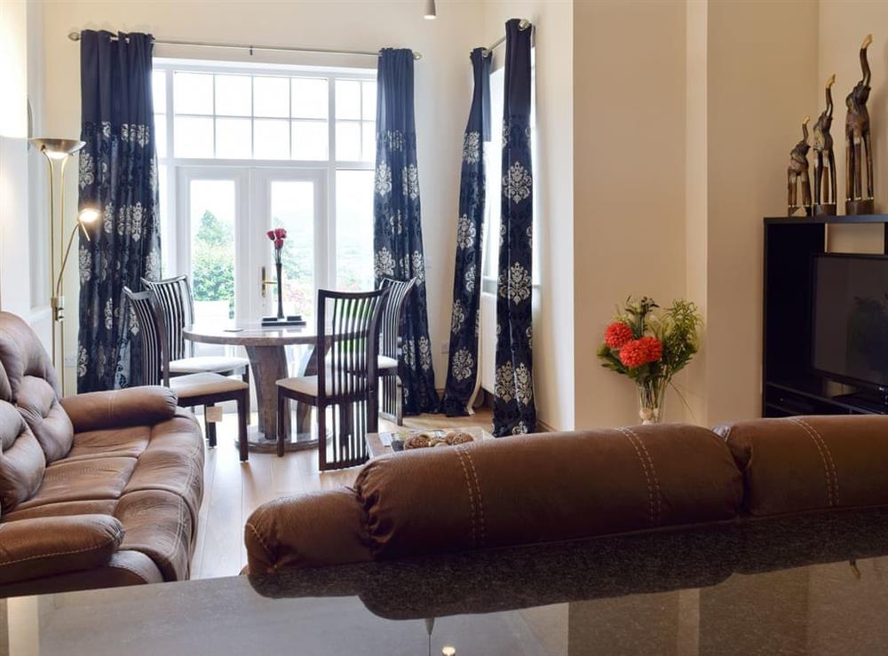 Spacious living area with lounge, dining area and kitchen at 5 Ladstock Hall (Deluxe) in Keswick, Cumbria