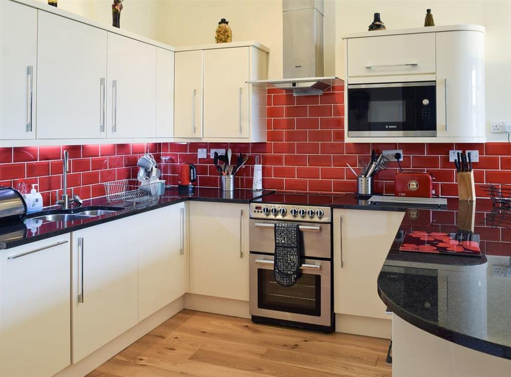 Well-equipped modern fitted kitchen at 5 Ladstock Hall (Deluxe) in Keswick, Cumbria