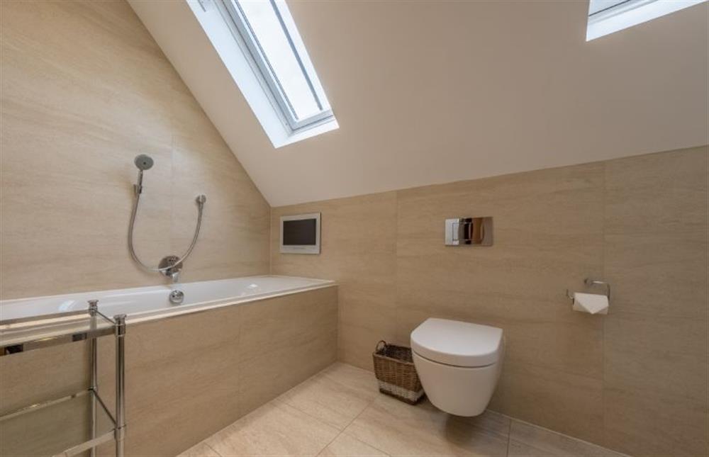 The family bathroom, with bath and handheld shower attachment  at 5 Manor Farm Barns, Brancaster