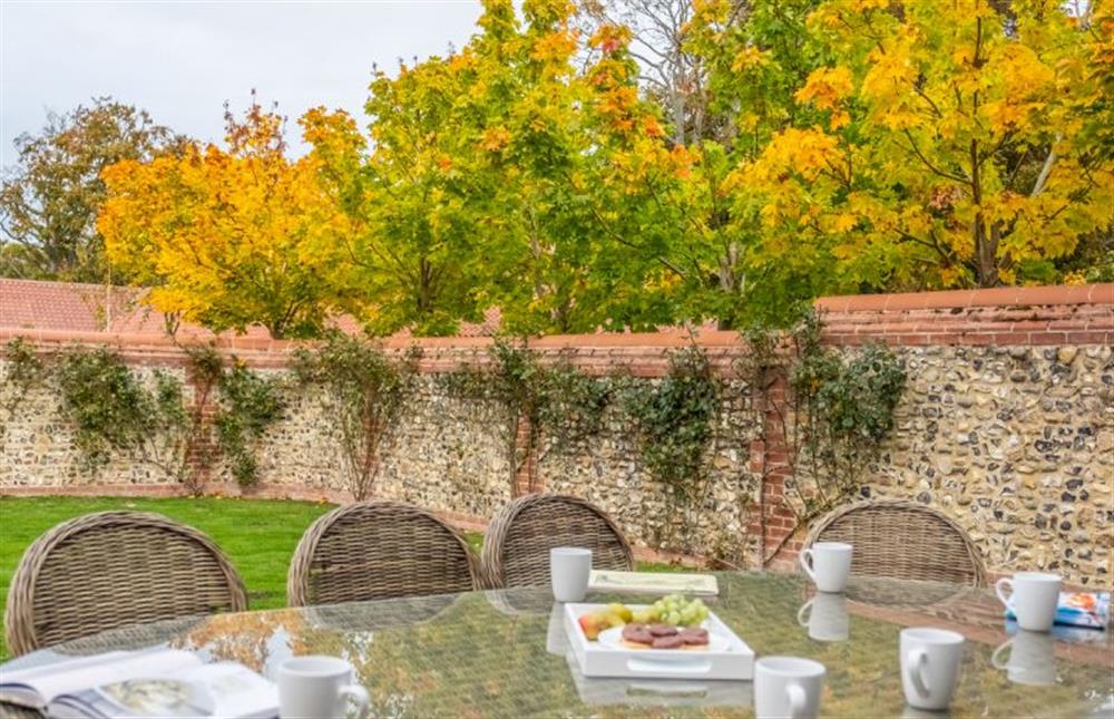 The garden is perfect for alfresco dining  at 5 Manor Farm Barns, Brancaster