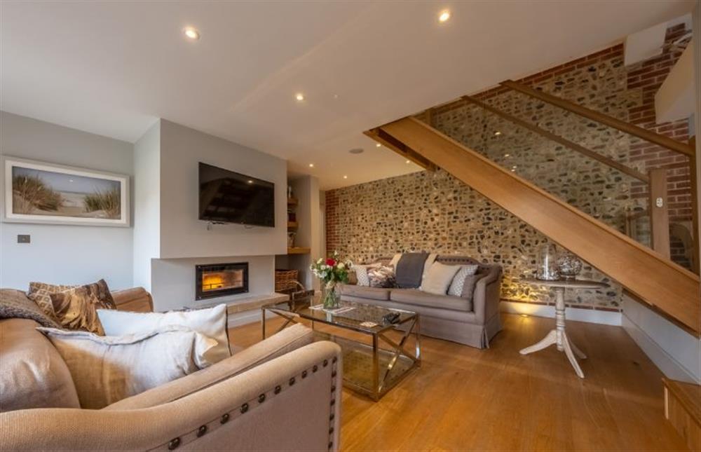 The sitting room leads through to bedrooms three and four  at 5 Manor Farm Barns, Brancaster