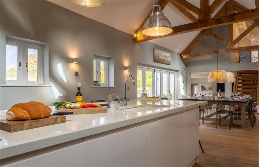 The well-equipped kitchen area, leading to the dining area  at 5 Manor Farm Barns, Brancaster