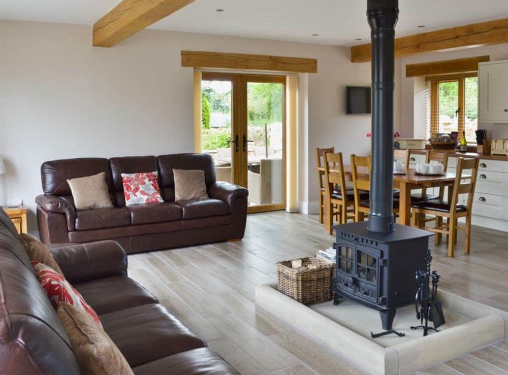 Open-plan designed living space with central wood-burner at 5 The Granary in Pendleton, near Clitheroe, Lancashire