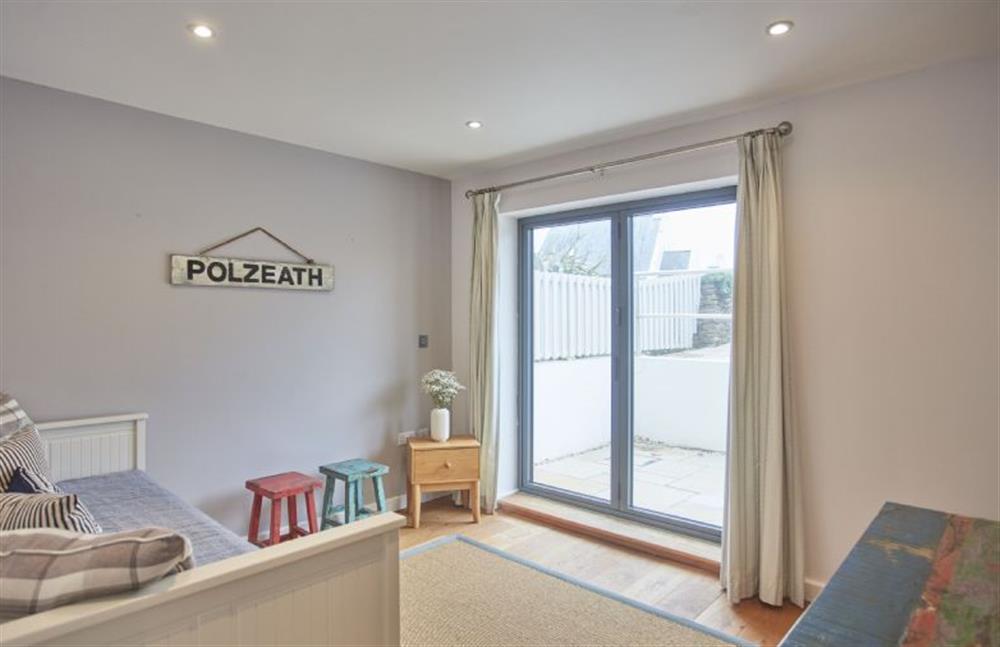 Bedroom four with bi-folding doors to the front of the property at 5 The Sands, Polzeath