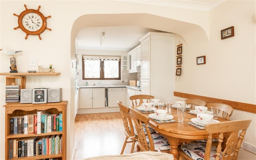 The dining table area is between the kitchen and the lounge at 55 Upper Maen Cottage in Maenporth