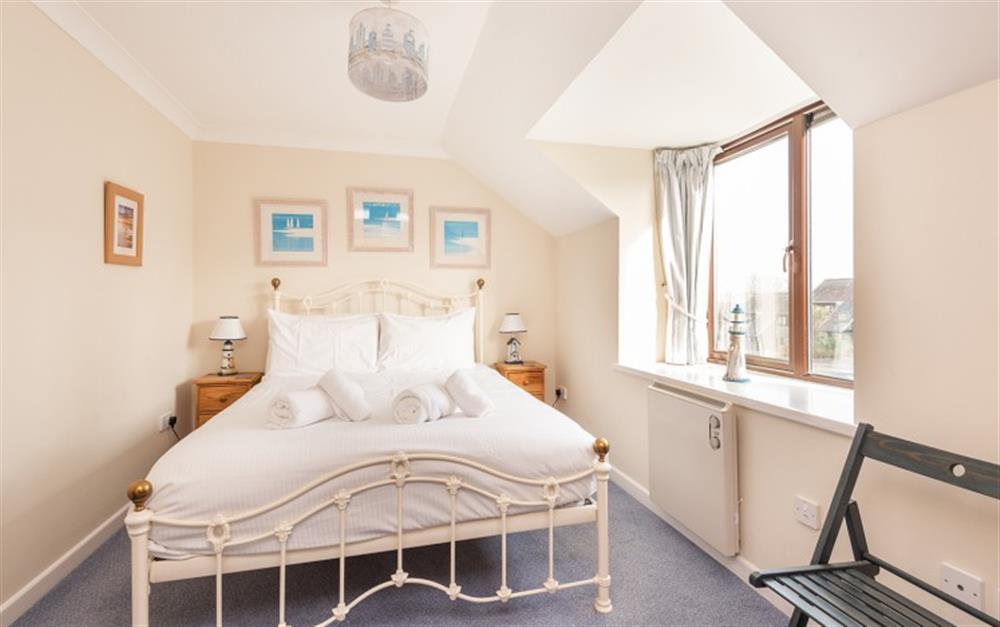 The pictures add apop of colour to the cream themed master bedroom at 55 Upper Maen Cottage in Maenporth